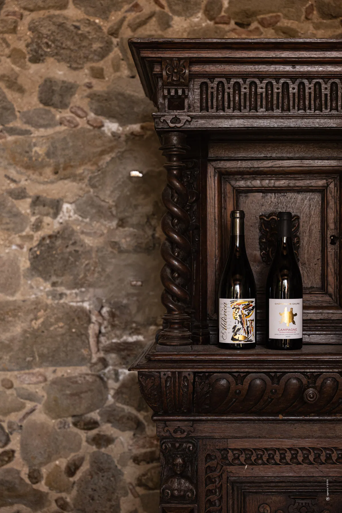 Château de Gaure bottles on an antique cabinet