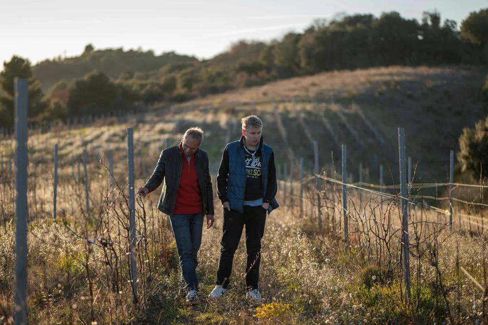 Pierre Fabre and his son walking the vines